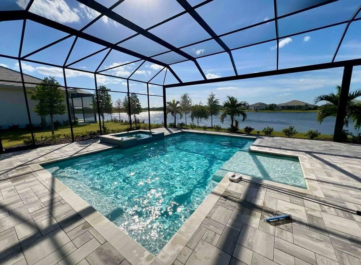 Splash Pros technician servicing a screened-in pool in Parrish, FL